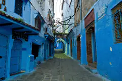 A blue-washed alley with arched doorways in Chefchaouen